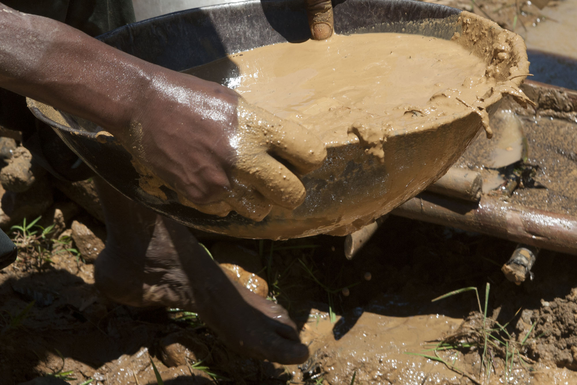 Informal gold diggers sift through sad and mud along the riverbeds in Ikolomani village in Kakamega county 500 km west of Nairobi Kenya. The then pan the sand in search of gold residues. The informal gold mining has been practiced for years in Ikolomani, sometimes leading to deaths when the mines curve in as they occasionally do. However, that has not deterred others in a county rated among the poor in the country. Over the weekend they participate in bull fighting competitions where the whole village comes together to ululate and celebrate the winner.